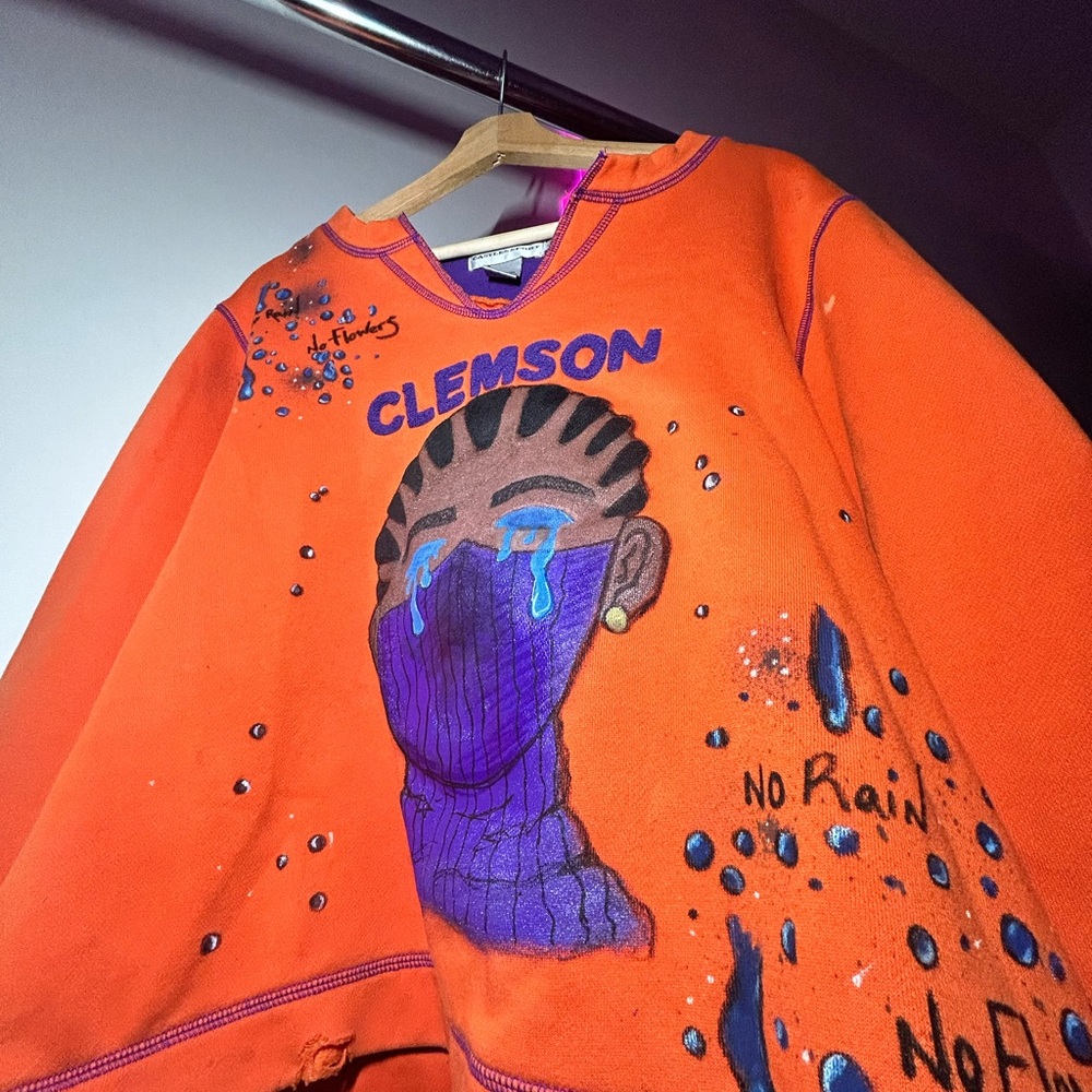 Vibrant Orange Crewneck Sweater with Purple Design